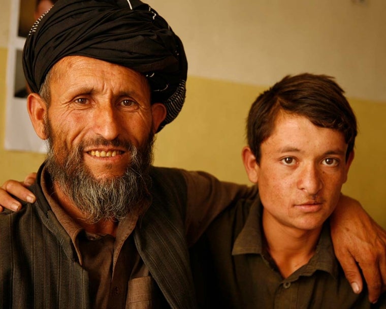 Father hugs son after cleft surgery